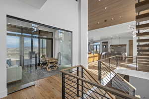 Interior space with a mountain view, light hardwood / wood-style floors, a high ceiling, and a chandelier