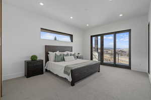 Carpeted bedroom featuring multiple windows and a mountain view