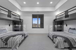 Bedroom featuring carpet floors and a tray ceiling