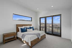 Carpeted bedroom with a mountain view, lofted ceiling, and access to outside