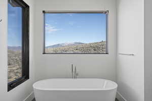 Bathroom featuring a mountain view and a bathtub