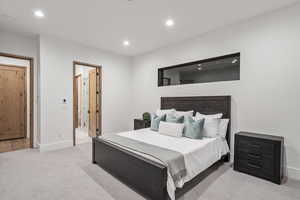 Carpeted bedroom featuring ensuite bathroom