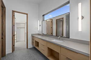 Bathroom featuring a shower with door and vanity