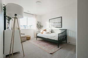 Bedroom featuring light colored carpet