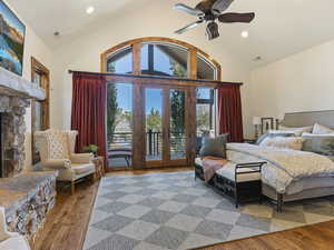 Bedroom featuring wood-type flooring, access to outside, and multiple windows