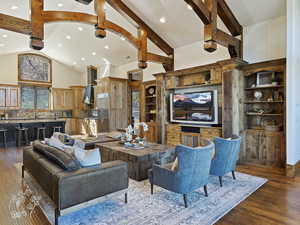 Living room featuring sink, beamed ceiling, dark hardwood / wood-style floors, and high vaulted ceiling