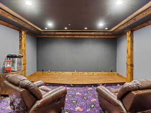 Home theater featuring decorative columns and ornamental molding