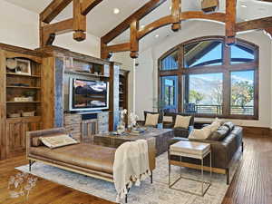 Living room with wood-type flooring and high vaulted ceiling