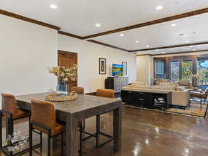 Dining area with ornamental molding and french doors