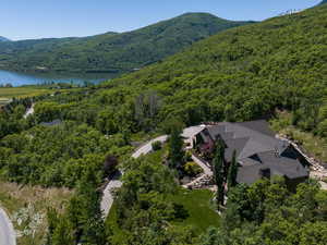 Birds eye view of property featuring a water and mountain view