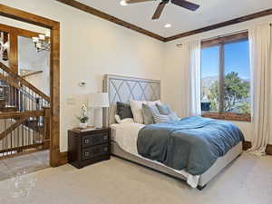 Bedroom featuring ceiling fan, light tile patterned floors, and ornamental molding