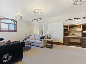 Carpeted living room featuring lofted ceiling