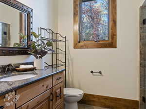 Bathroom with tile patterned floors, vanity, and toilet