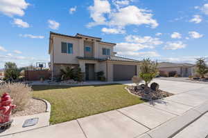 Mediterranean / spanish house with a front yard and a garage