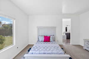 Bedroom featuring carpet and ensuite bath