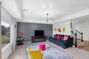 Living room featuring hardwood / wood-style flooring and an inviting chandelier