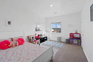 Bedroom featuring light colored carpet