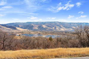 Property view of mountains with a water view