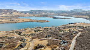 Birds eye view of property with a water and mountain view