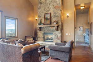 Living room featuring a fireplace and a high ceiling