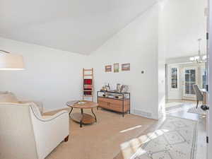 Living room with high vaulted ceiling and a chandelier