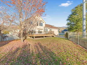 Rear view of house featuring a wooden deck