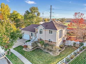 View of front of house featuring a front lawn and a garage