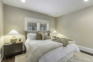 Bedroom with dark wood-type flooring