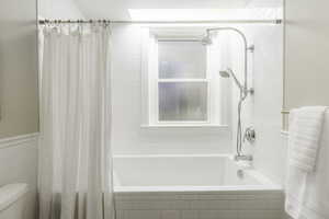 Bathroom with shower / bath combo and toilet