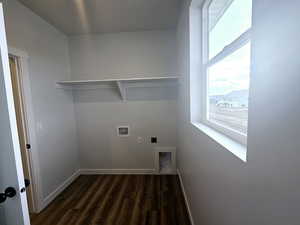 Clothes washing area with electric dryer hookup, washer hookup, and dark hardwood / wood-style floors