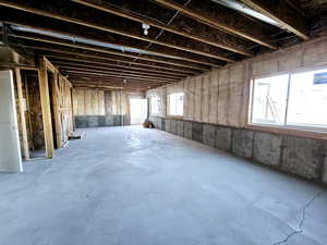 Misc room featuring a healthy amount of sunlight and concrete floors