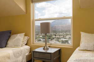 Bedroom with multiple windows and a mountain view