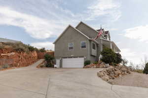 View of side of home with a garage