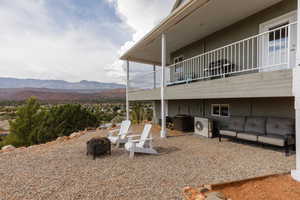 View of yard featuring a mountain view, a balcony, and ac unit