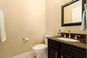 Bathroom with tile patterned flooring, vanity, and toilet