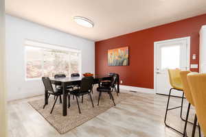 Dining area with light hardwood / wood-style floors