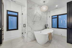 Bathroom featuring separate shower and tub