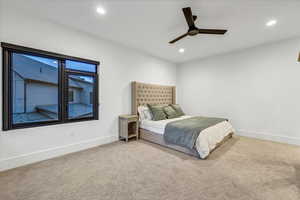 Carpeted bedroom featuring ceiling fan