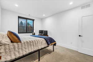 Bedroom with light colored carpet