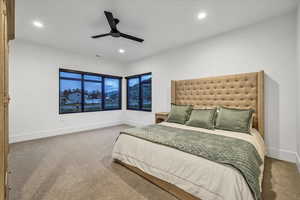 Carpeted bedroom featuring ceiling fan