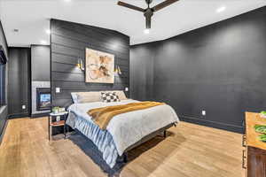 Bedroom with ceiling fan and light hardwood / wood-style flooring