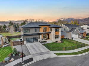 View of front of home featuring a mountain view, a garage, and a yard