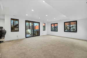 Unfurnished living room featuring light carpet