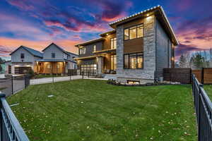 View of front of home with a yard and a garage