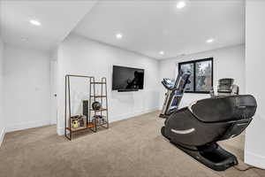 Exercise room featuring light carpet