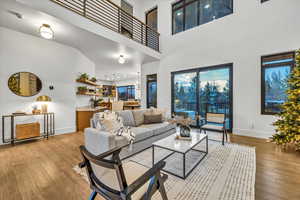 Living room featuring a high ceiling and light wood-type flooring