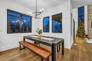 Dining area featuring hardwood / wood-style floors and a notable chandelier