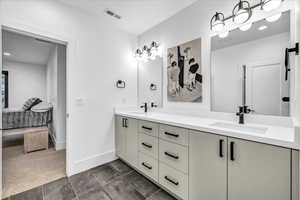 Bathroom featuring tile patterned flooring and vanity