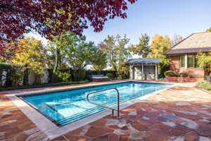 View of pool with an outbuilding and a patio