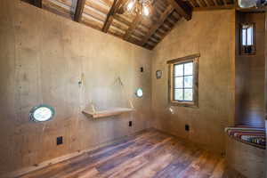 Clothes washing area with wooden walls, hardwood / wood-style flooring, and wooden ceiling